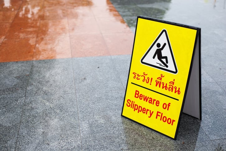 business with slippery floor warning sign 