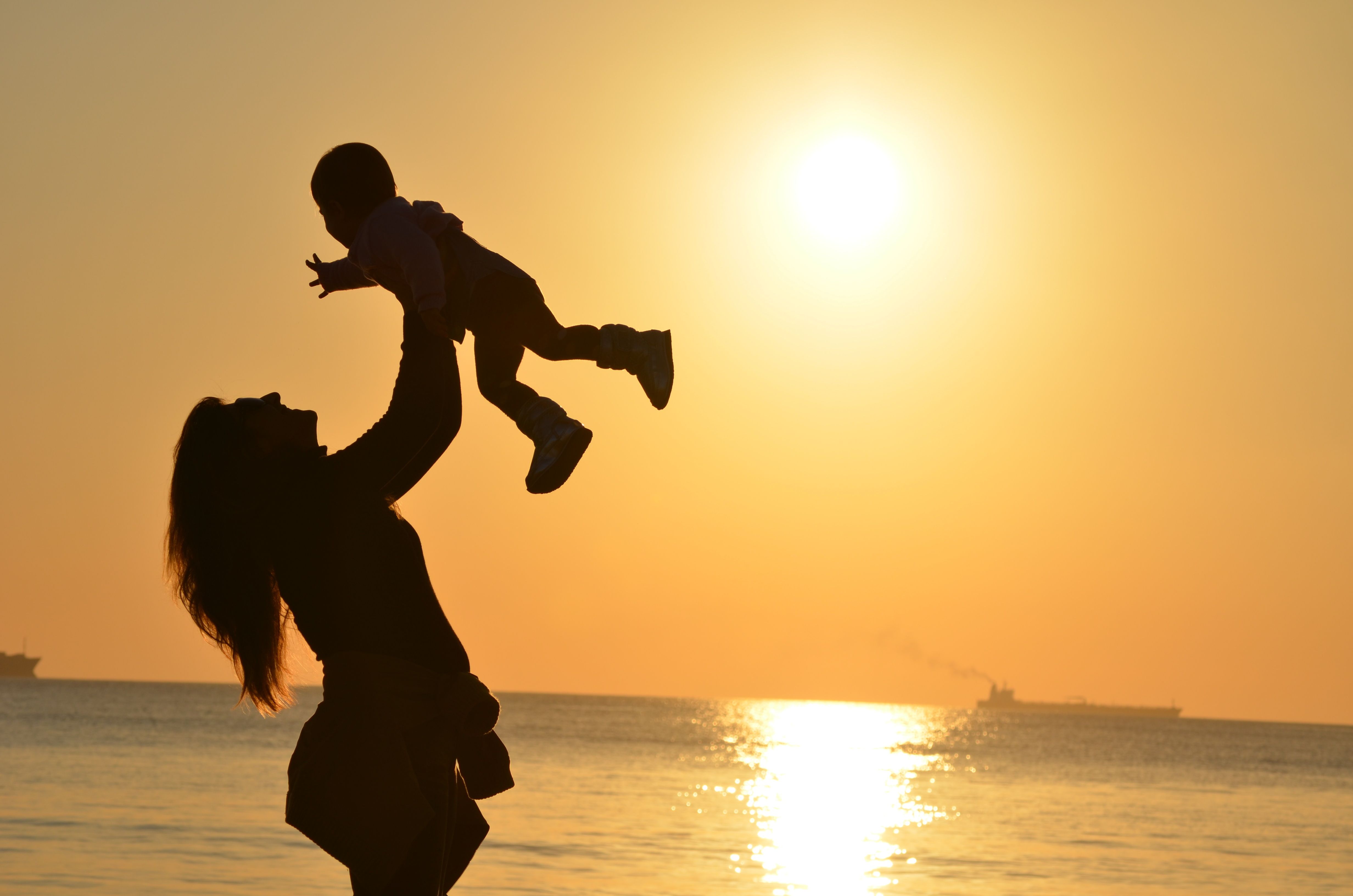 woman with baby by ocean