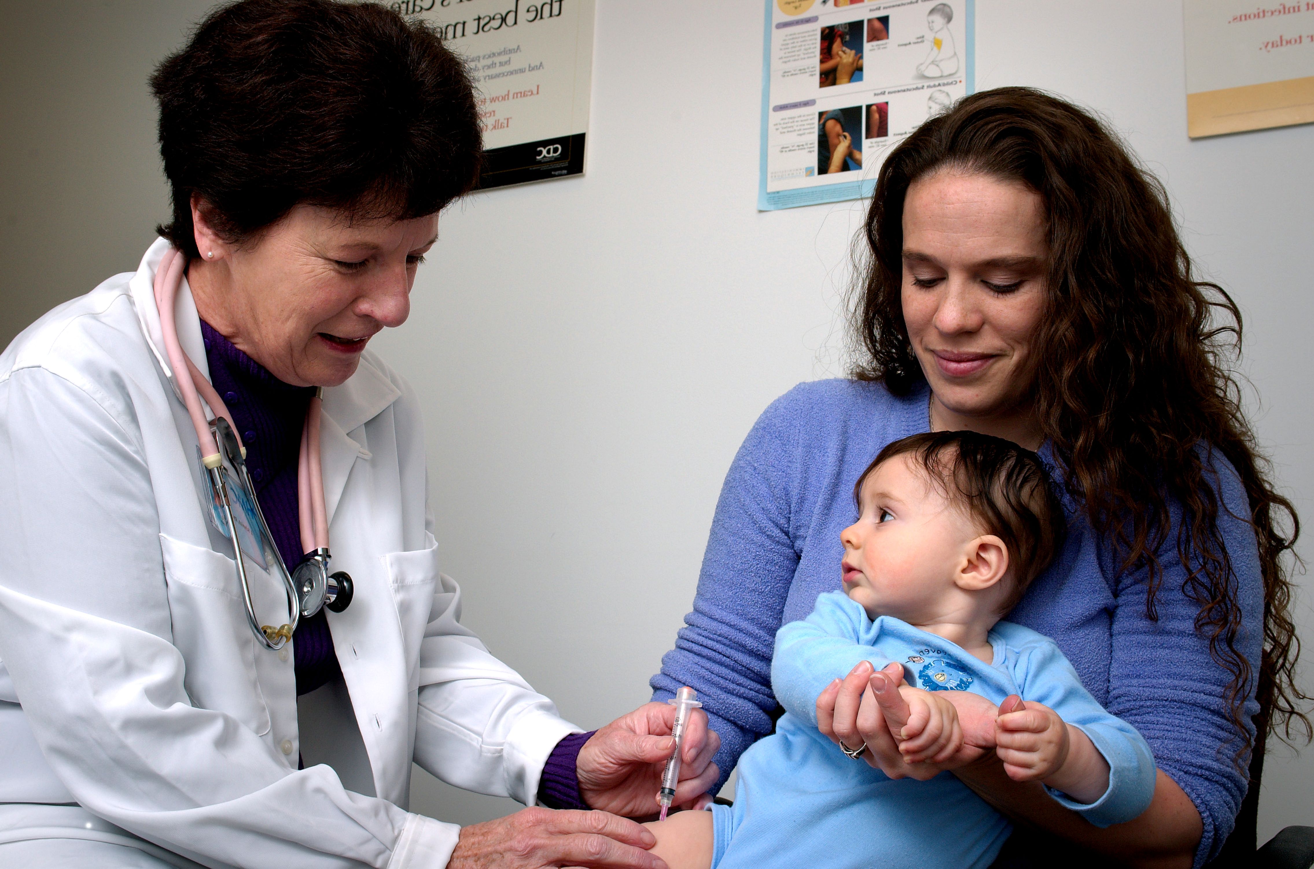 baby getting a shot from a doctor