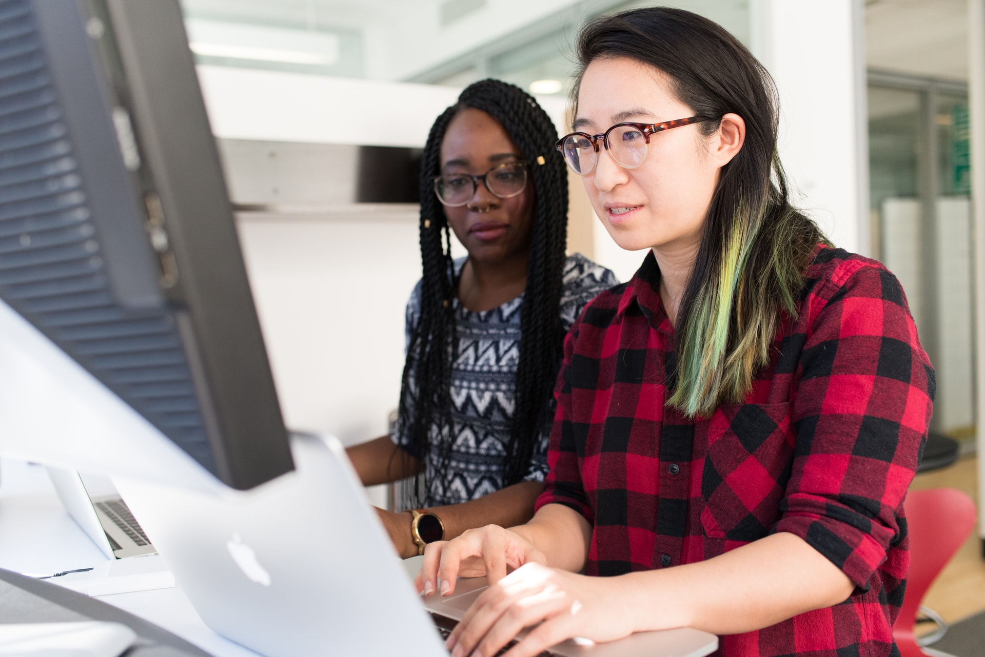 image of two women working on a project together