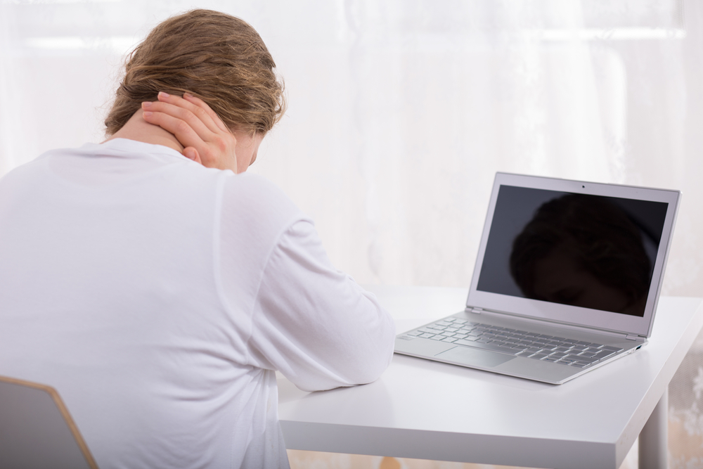 image of sad woman by laptop